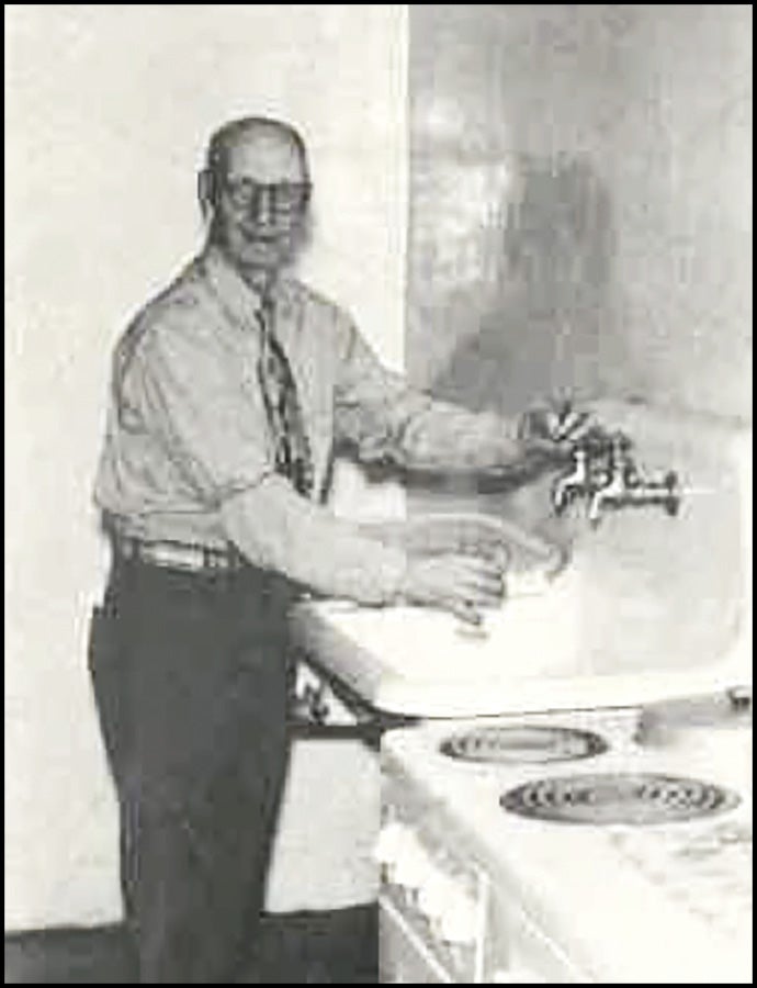 vintage photo of man using faucet